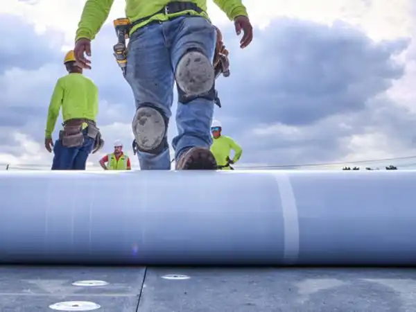 Worker rolling out TPO sheet