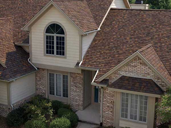 Front view of a typical mid-class home with red Owens Corning shingles on its roof